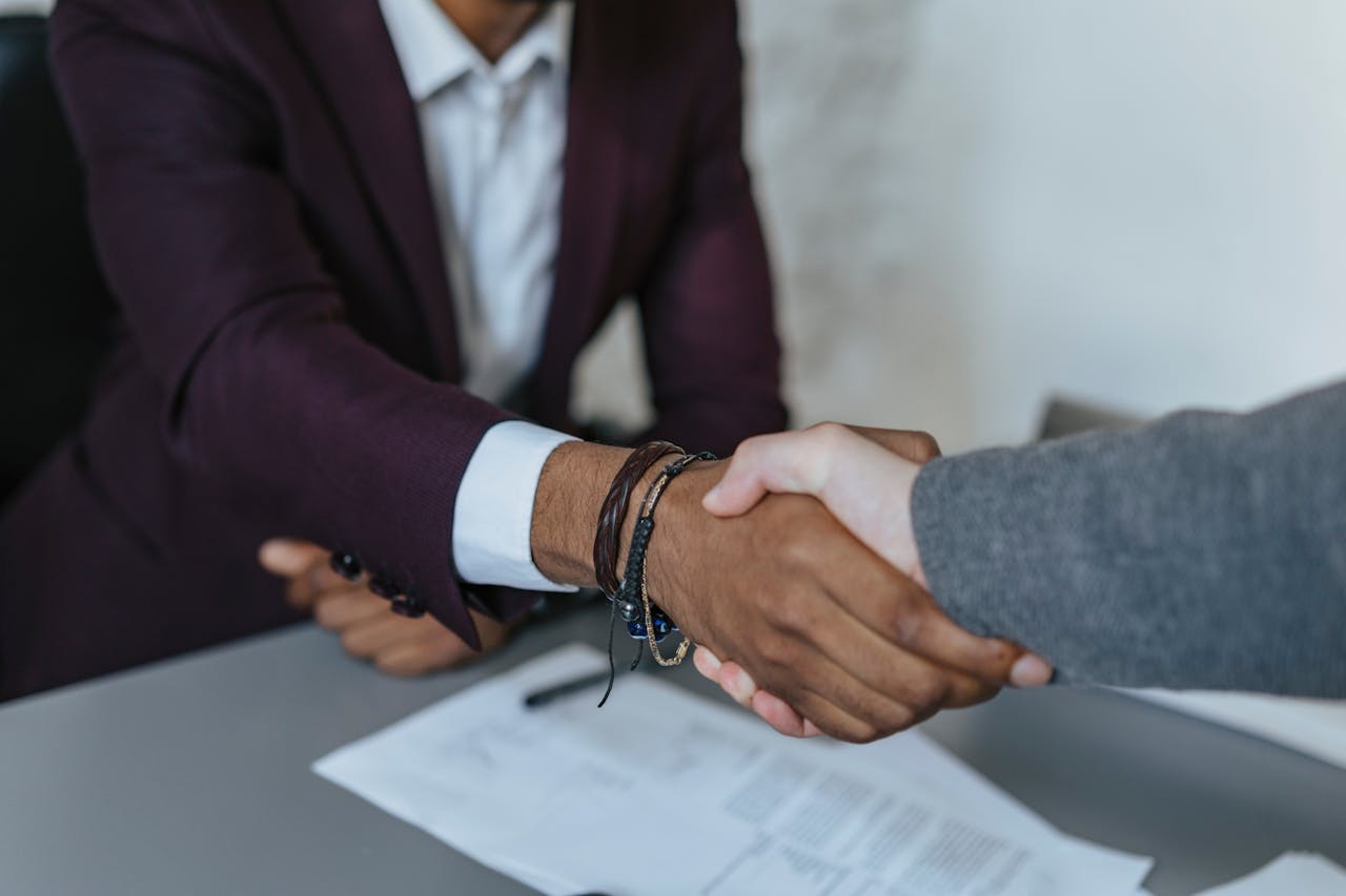 Close-up of a business handshake symbolizing agreement and partnership indoors.